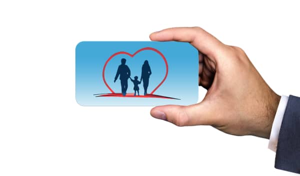 Hand holding up card that shows outline of loving family