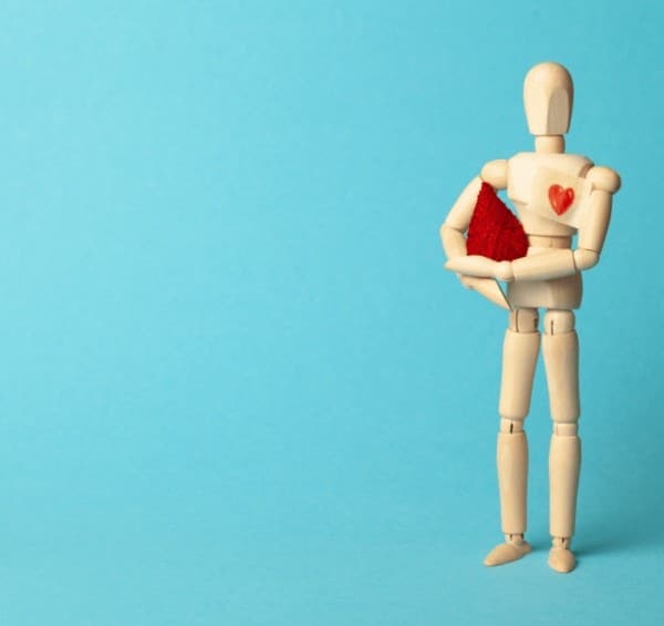 Wooden figure with heart drawn on chest